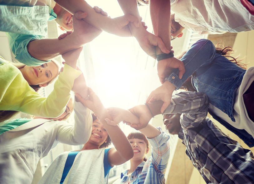 group of international students holding hands
